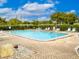 Community pool with lounge chairs and patio area at 4222 Trucious Pl # 4222, New Port Richey, FL 34652