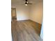 Bright bedroom features a ceiling fan, wood-style flooring, and a spacious closet at 2070 World Parkway Blvd # 50, Clearwater, FL 33763