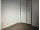 Cozy bedroom features wood floors and a closet with white louvered doors at 2070 World Parkway Blvd # 50, Clearwater, FL 33763