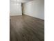 Empty living room featuring wood-style flooring, fresh paint, and modern lighting at 2070 World Parkway Blvd # 50, Clearwater, FL 33763