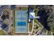 Aerial view of tennis and pickleball courts, a clubhouse and pond at 2070 World Parkway Blvd # 50, Clearwater, FL 33763