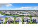 Wide aerial view of a residential neighborhood surrounding a scenic lake with a fountain at 17518 Canopy Pl, Bradenton, FL 34211