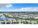 Aerial view showcasing a residential community with a central pond, fountain and lush landscaping at 17518 Canopy Pl, Bradenton, FL 34211