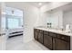 Stylish bathroom with dual sinks, granite countertops, and dark wood cabinetry at 17518 Canopy Pl, Bradenton, FL 34211