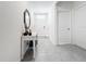 Bright foyer features a white console table with mirror accent, tile flooring and white doors at 17518 Canopy Pl, Bradenton, FL 34211