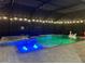 Night shot of a screened pool and spa, featuring color-changing LED lighting for a fun ambiance at 17518 Canopy Pl, Bradenton, FL 34211