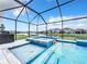 Screened pool and spa with waterfront view provides the perfect outdoor relaxation and entertainment space at 17518 Canopy Pl, Bradenton, FL 34211