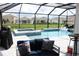 Outdoor pool and spa area with lounge seating and a screened enclosure at 17518 Canopy Pl, Bradenton, FL 34211