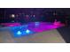 Night view of the pool and spa with colorful lighting at 17518 Canopy Pl, Bradenton, FL 34211