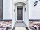 Dark brown front door with a welcoming mat at 17518 Canopy Pl, Bradenton, FL 34211