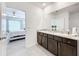 Clean bathroom with double vanity, granite countertop and a view of the bedroom at 17518 Canopy Pl, Bradenton, FL 34211