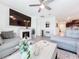 Bright living room featuring a large TV and a cozy fireplace at 17518 Canopy Pl, Bradenton, FL 34211