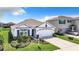 White and gray one-story house with a two-car garage and well-manicured lawn at 17518 Canopy Pl, Bradenton, FL 34211