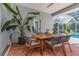 Outdoor patio with seating area, dining table, and lush tropical plants at 2228 Valrico Forest Dr, Valrico, FL 33594