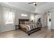 Spacious main bedroom with wood bed frame and access to the bathroom at 2228 Valrico Forest Dr, Valrico, FL 33594