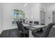 Bright dining room with a glass-top table, gray chairs, and large windows with plantation shutters at 2228 Valrico Forest Dr, Valrico, FL 33594