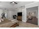 Main bedroom with large TV, dresser and view into the kitchen and living room at 2228 Valrico Forest Dr, Valrico, FL 33594