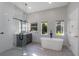 Bathroom with a soaking tub, walk-in shower, and gray vanity at 2228 Valrico Forest Dr, Valrico, FL 33594