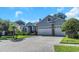 Two-story home with a three-car garage and manicured lawn at 2228 Valrico Forest Dr, Valrico, FL 33594