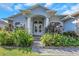 Beautiful two-story home with lush landscaping and a brick walkway leading to the front entrance at 2228 Valrico Forest Dr, Valrico, FL 33594