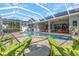 Relaxing poolside view with lounge chairs under screened enclosure at 2228 Valrico Forest Dr, Valrico, FL 33594