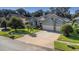 Two-story house with a three-car garage and lush landscaping at 2228 Valrico Forest Dr, Valrico, FL 33594