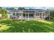 Spacious backyard with lush lawn and screened pool area at 2228 Valrico Forest Dr, Valrico, FL 33594