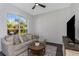 Relaxing living room with sectional sofa, large window, and flat-screen TV at 2228 Valrico Forest Dr, Valrico, FL 33594
