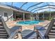 Refreshing pool with lounge chairs and covered patio at 2228 Valrico Forest Dr, Valrico, FL 33594