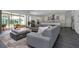 Open concept living area with a large sectional sofa, pool view, and kitchen access at 2228 Valrico Forest Dr, Valrico, FL 33594