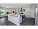 Modern kitchen with white cabinets, blue island, and a herringbone backsplash at 2228 Valrico Forest Dr, Valrico, FL 33594