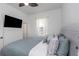 Bright bedroom with a king-size bed and large TV at 2228 Valrico Forest Dr, Valrico, FL 33594