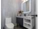 Modern bathroom with floating vanity, marble countertops, and large mirror at 2228 Valrico Forest Dr, Valrico, FL 33594