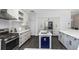 Open concept kitchen with white cabinets, island, and stainless steel appliances at 2228 Valrico Forest Dr, Valrico, FL 33594