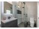 Elegant bathroom with a frameless shower, modern vanity, and large mirror at 2228 Valrico Forest Dr, Valrico, FL 33594