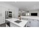 Bright kitchen features a large island with a gold faucet and stainless steel appliances at 2228 Valrico Forest Dr, Valrico, FL 33594