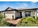 Single story house with gray roof, brick walkway, and landscaping at 19443 Sea Glass Cir, Land O Lakes, FL 34638