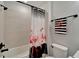 Bathroom with a tub and shower, featuring a flamingo-themed shower curtain at 19443 Sea Glass Cir, Land O Lakes, FL 34638