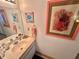 Bathroom with vanity, coral art, and pink towels at 6009 Sea Ranch Dr # 301, Hudson, FL 34667