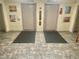 Building lobby with two elevators and plush floor mats at 6009 Sea Ranch Dr # 301, Hudson, FL 34667