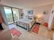 Main bedroom with a king-size bed and balcony access at 6009 Sea Ranch Dr # 214, Hudson, FL 34667