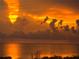 Orange sunset over calm waters with a cloudy sky at 6009 Sea Ranch Dr # 214, Hudson, FL 34667