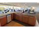 Community kitchen with ample seating and granite countertops at 6009 Sea Ranch Dr # 214, Hudson, FL 34667