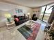 Relaxing living room with leather recliner and a colorful rug at 6009 Sea Ranch Dr # 214, Hudson, FL 34667