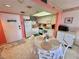 Bright kitchen and dining area with white cabinetry and table for four at 6009 Sea Ranch Dr # 214, Hudson, FL 34667