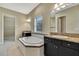 Elegant bathroom with a garden tub, double vanity, and granite countertop at 1005 Sonesta Ave, Brandon, FL 33511
