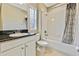 Well-lit bathroom, featuring a granite countertop and shower/tub combo at 1005 Sonesta Ave, Brandon, FL 33511