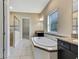Elegant bathroom with soaking tub, walk-in shower, and double vanity at 1005 Sonesta Ave, Brandon, FL 33511