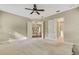 Bright bedroom with carpet flooring, ceiling fan, and access to bathroom at 1005 Sonesta Ave, Brandon, FL 33511