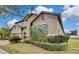 Two-story house with tan exterior, landscaping, and a palm tree at 1005 Sonesta Ave, Brandon, FL 33511